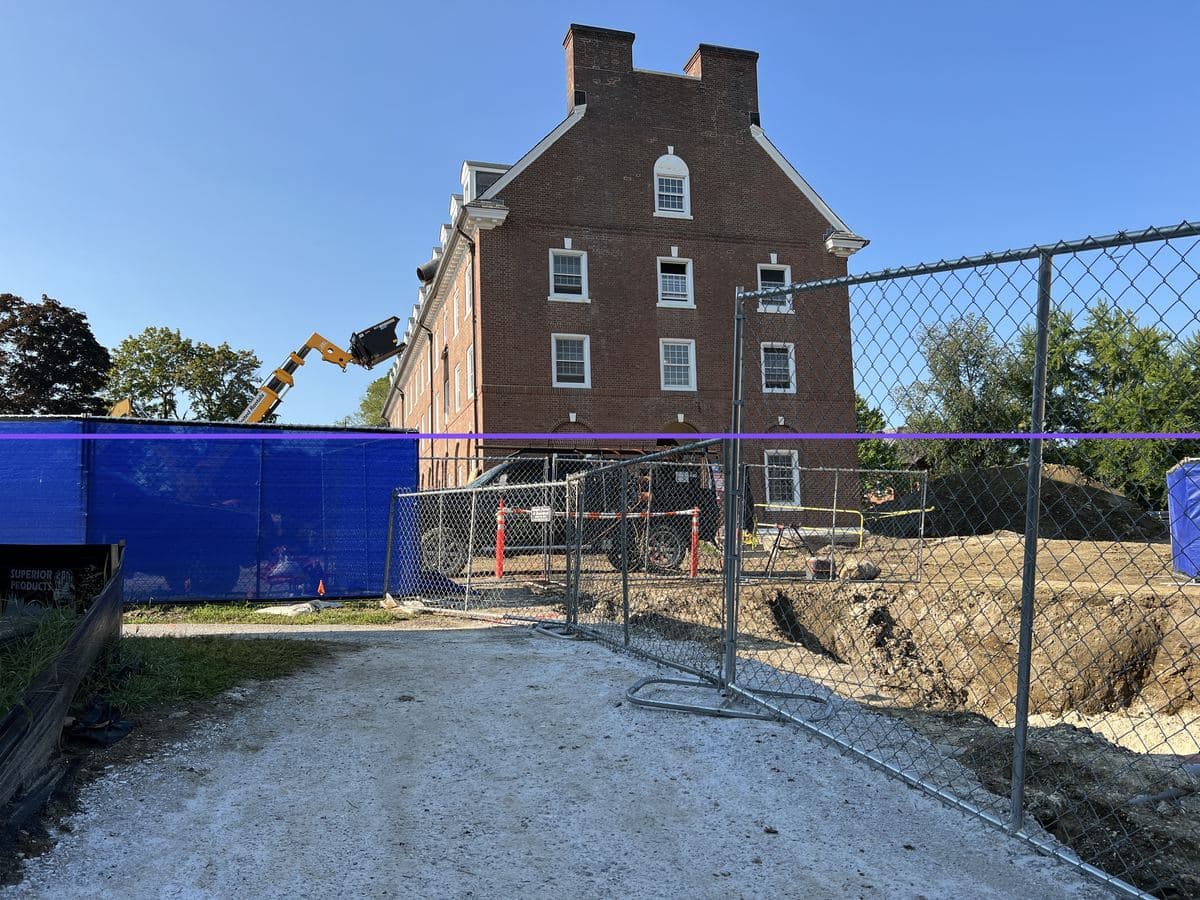 Memorial Horizon in progress — the reference, shot through the fence